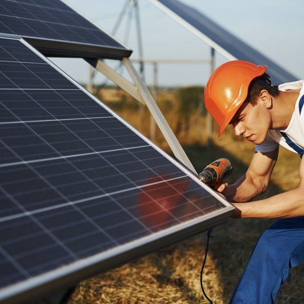 Services 1 using-cordless-screwdriver-male-worker-in-blue-uniform-outdoors-with-solar-batteries-at-sunny-day.jpg